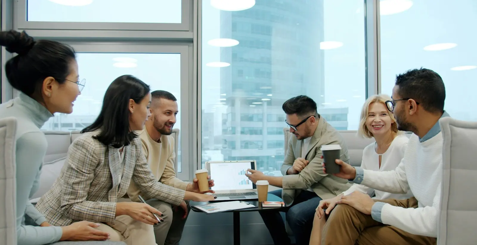 Team meeting in an office overlooking the Dubai skyline