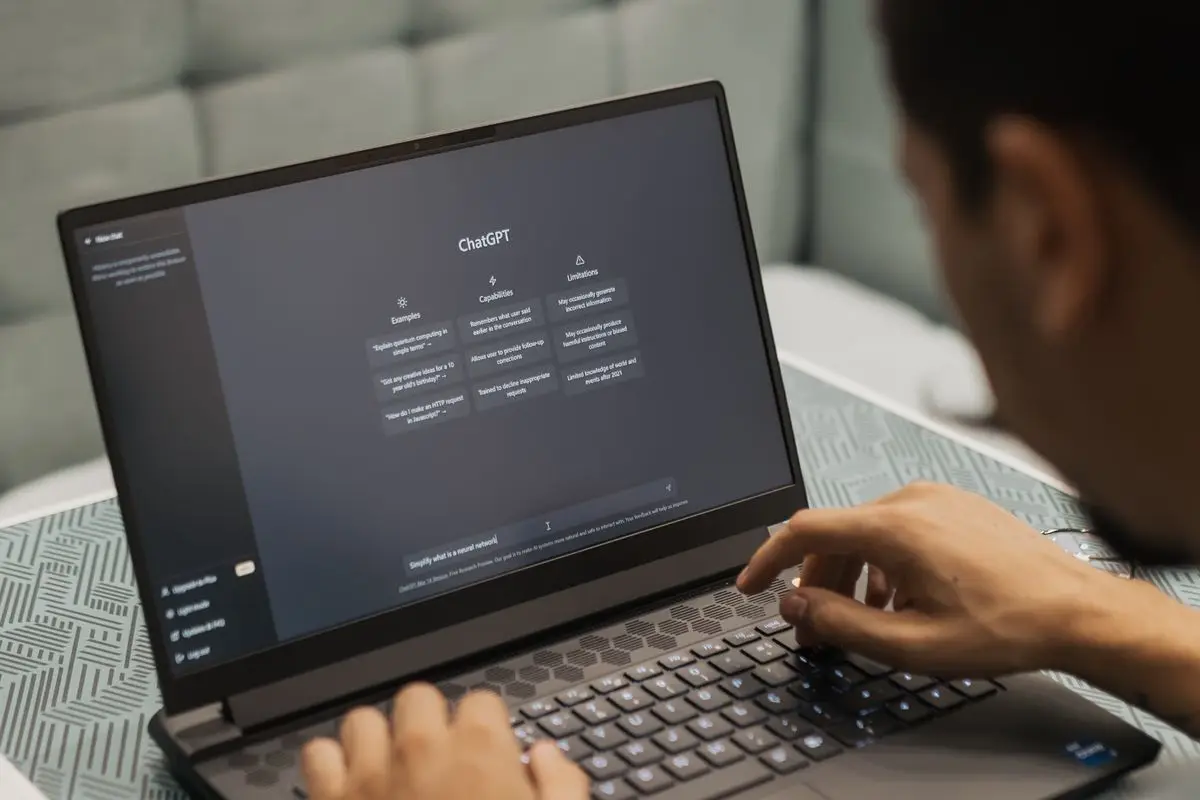 Business professional researching using ChatGPT on a laptop
