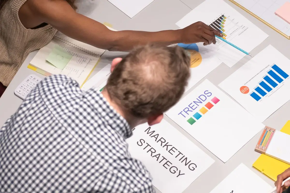 Team discussing search marketing strategy with charts and documents
