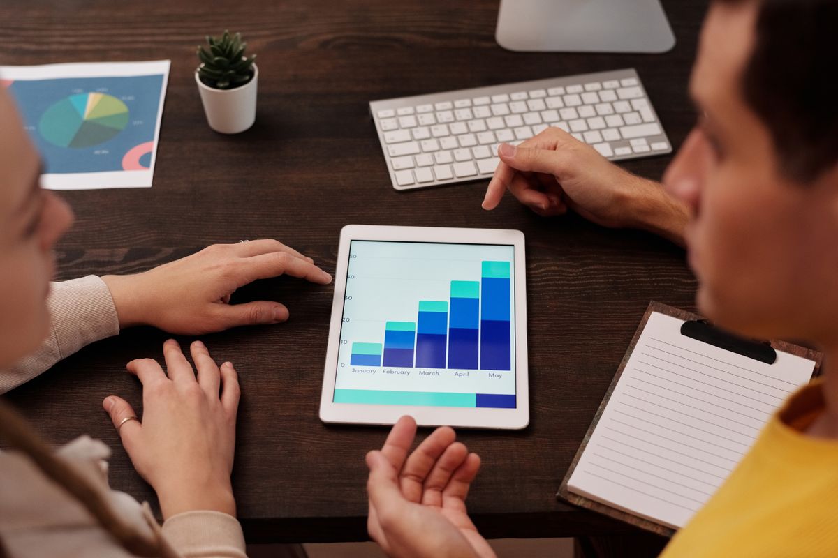 Marketing team reviewing SEO performance graphs on a tablet