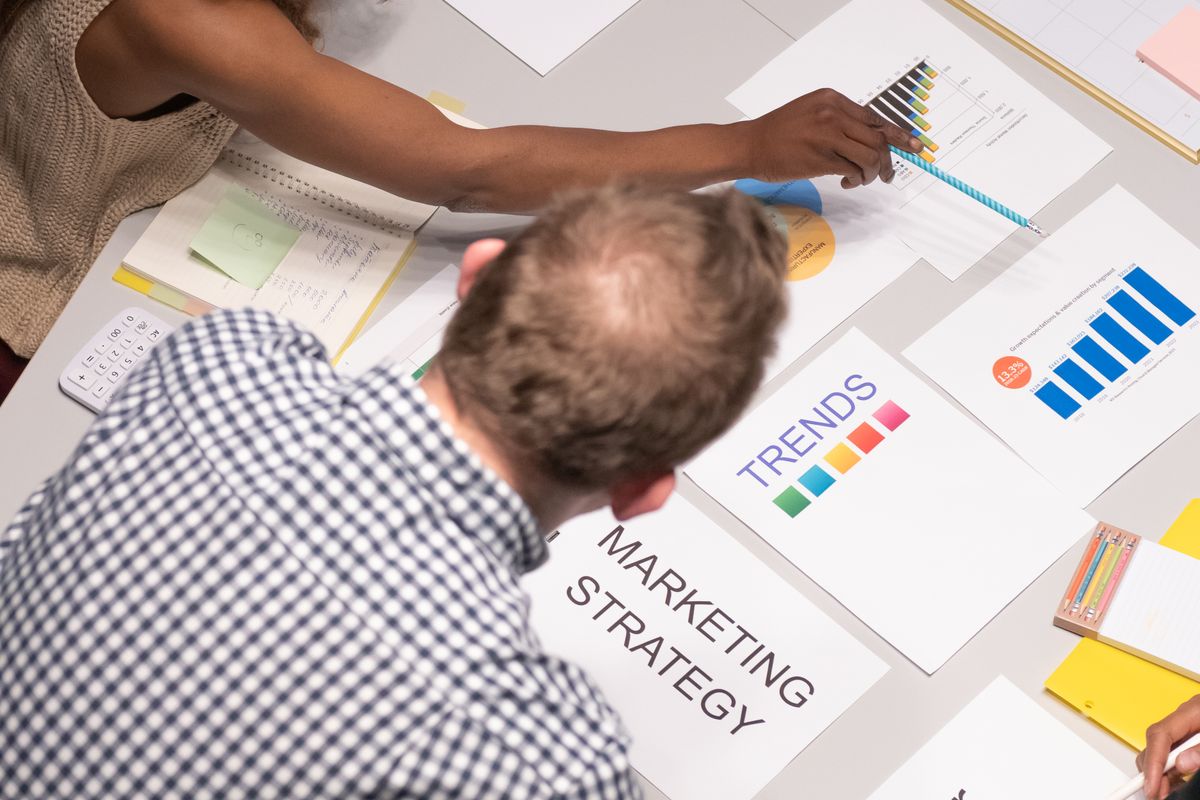 Team discussing search marketing strategy with charts and documents