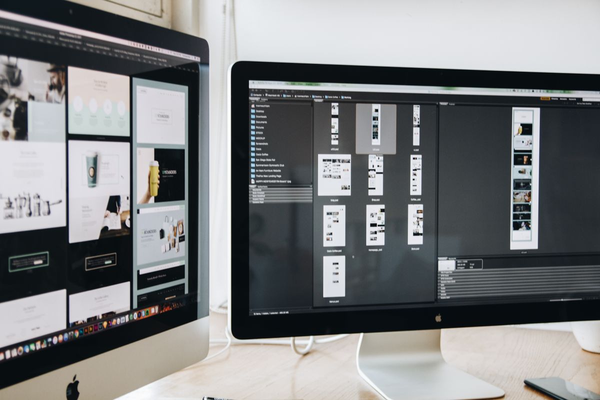 Modern workspace with website design projects on dual monitors